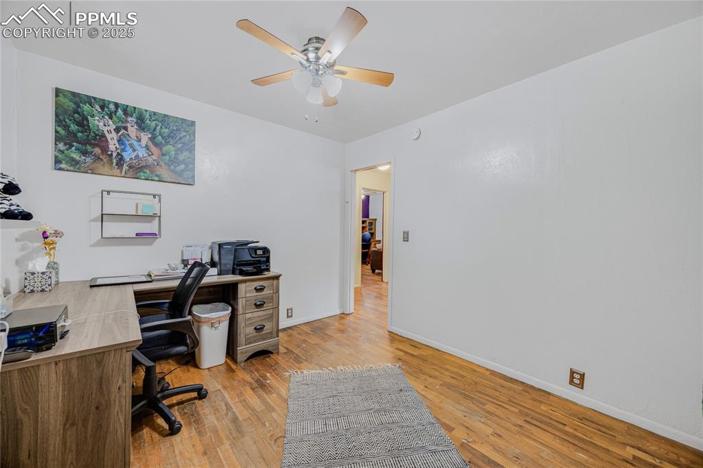 Image 17 of 31: Home office with light wood-style floors and a ceiling fan