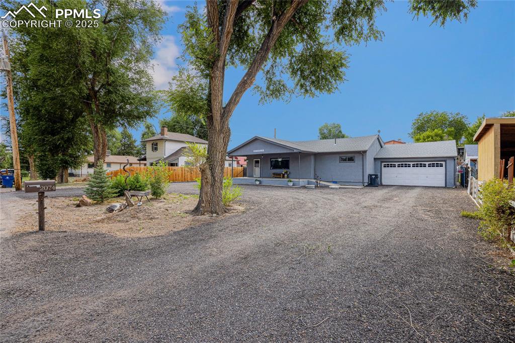 Image 2 of 31: View of front of house with a garage and driveway