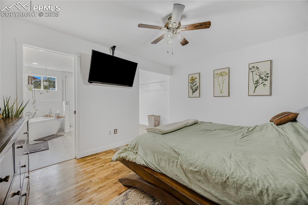 Image 21 of 31: Bedroom with light wood-type flooring and a ceiling fan