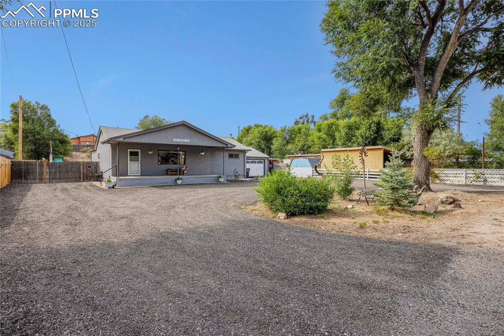 Image 4 of 31: View of front of home with a garage and stucco siding