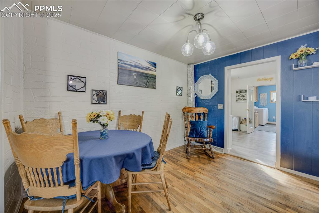 Image 8 of 31: Dining room featuring wood finished floors and washer / dryer