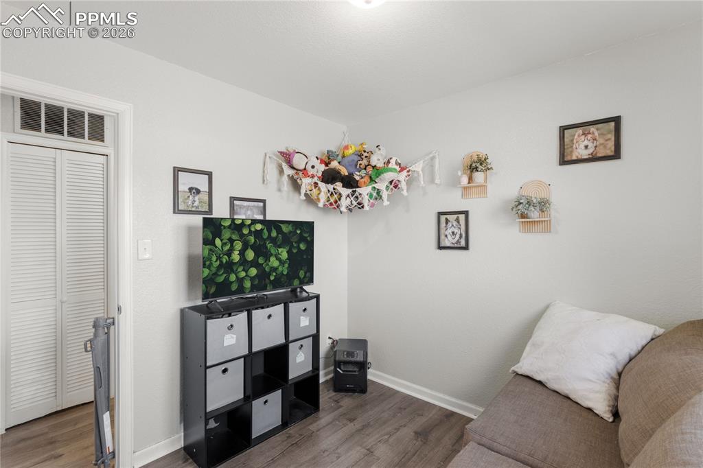 Image 11 of 32: Sitting room featuring baseboards and wood finished floors