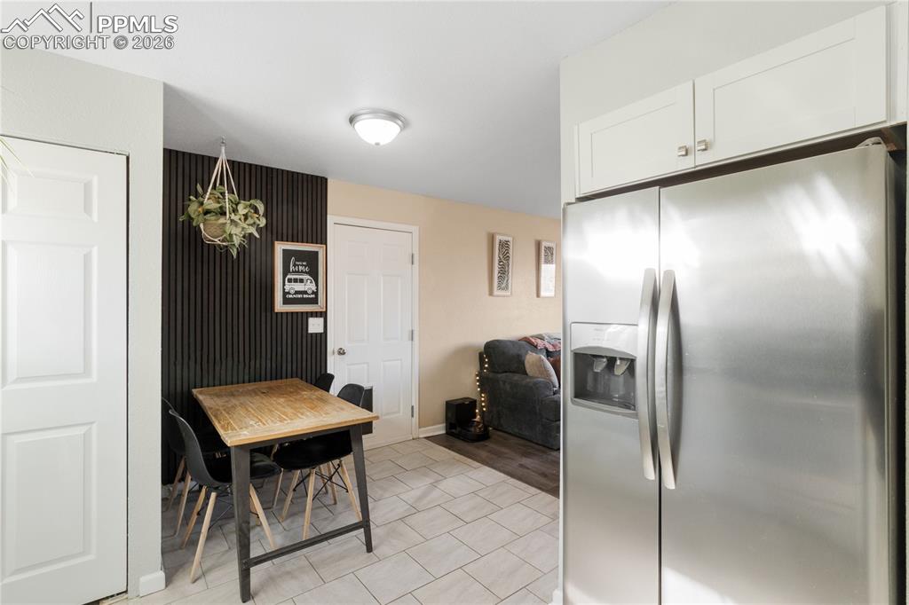Image 15 of 32: Dining area with baseboards and light tile patterned floors