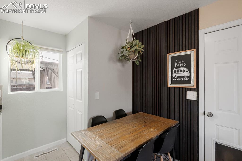 Image 16 of 32: Dining space with baseboards and light tile patterned floors