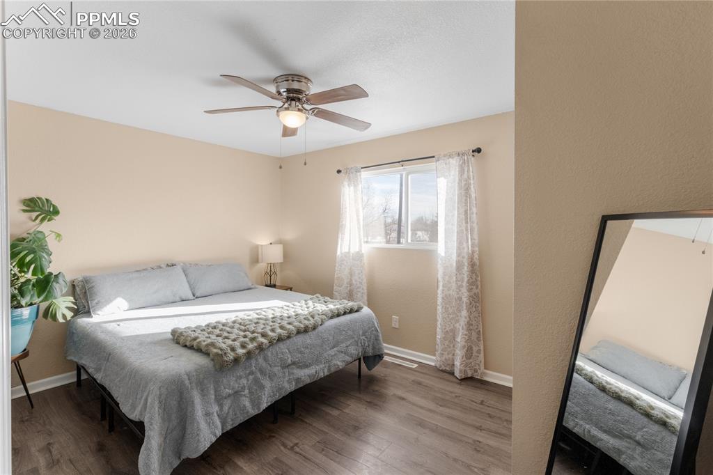 Image 18 of 32: Bedroom featuring wood finished floors and a ceiling fan
