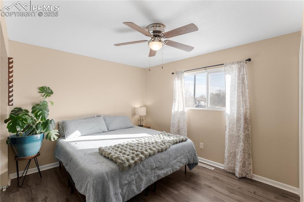 Image 19 of 32: Bedroom featuring dark wood-style flooring and a ceiling fan