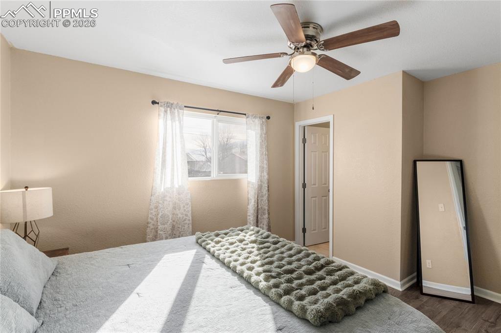 Image 20 of 32: Bedroom with a ceiling fan and wood finished floors