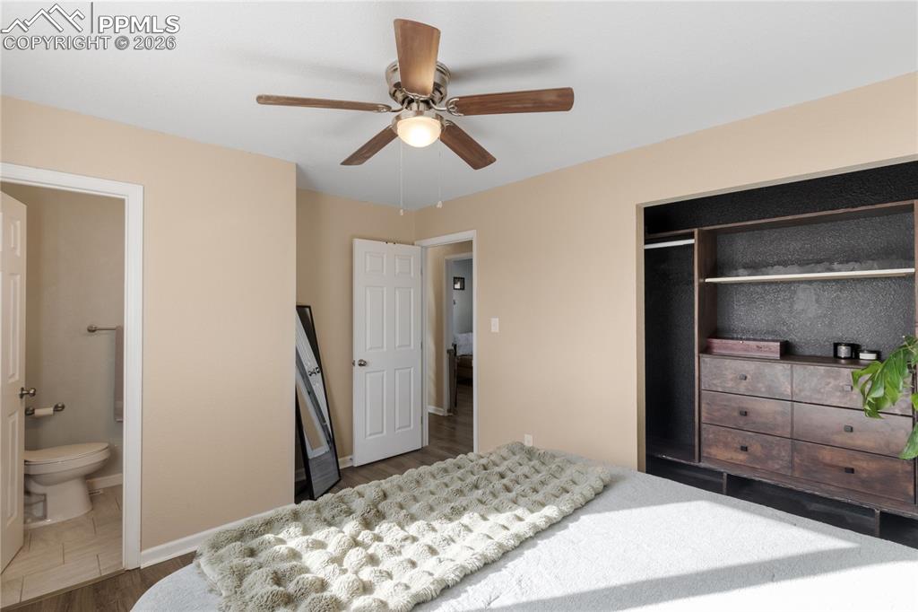 Image 22 of 32: Bedroom featuring dark wood-style flooring, ceiling fan, a closet, and conn