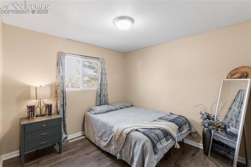Image 24 of 32: Bedroom featuring dark wood finished floors