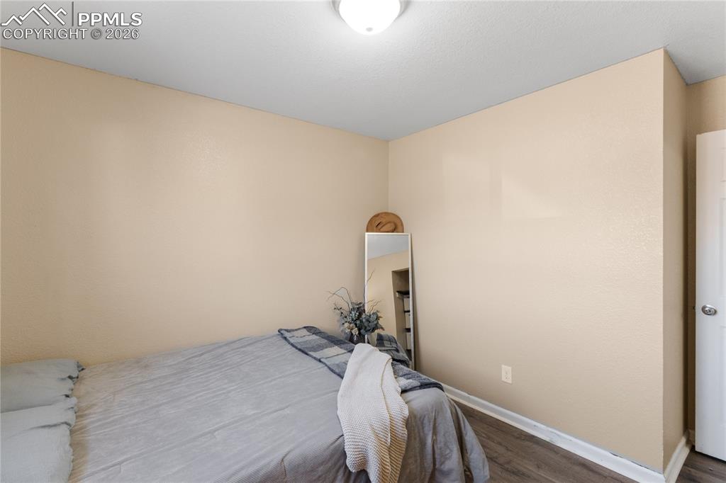 Image 25 of 32: Bedroom featuring wood finished floors and baseboards