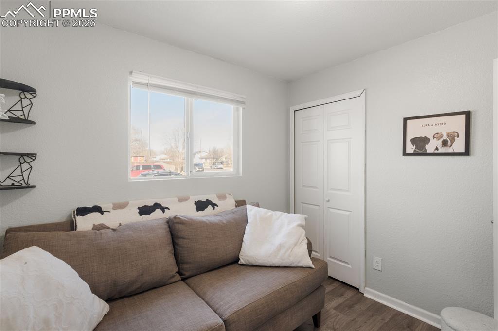 Image 9 of 32: Living room featuring dark wood finished floors and a textured wall