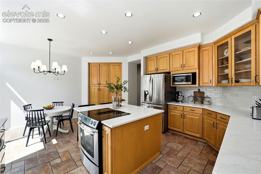 Image 19 of 50: Updated kitchen featuring stainless steel appliances, light wood cabinetry,