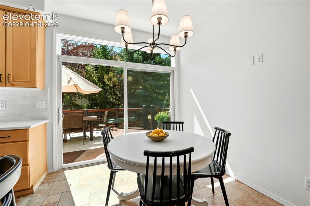 Image 21 of 50: Eat in kitchen with a view of the deck and yard