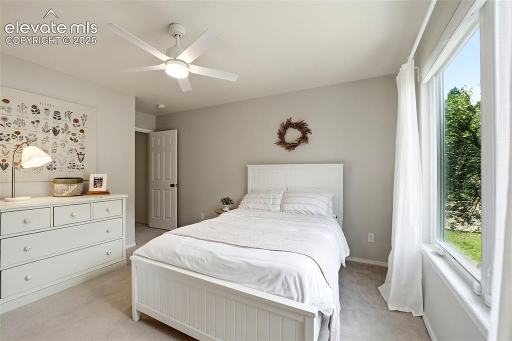Image 35 of 50: Secondary upstairs bedroom with large window and walk in closet