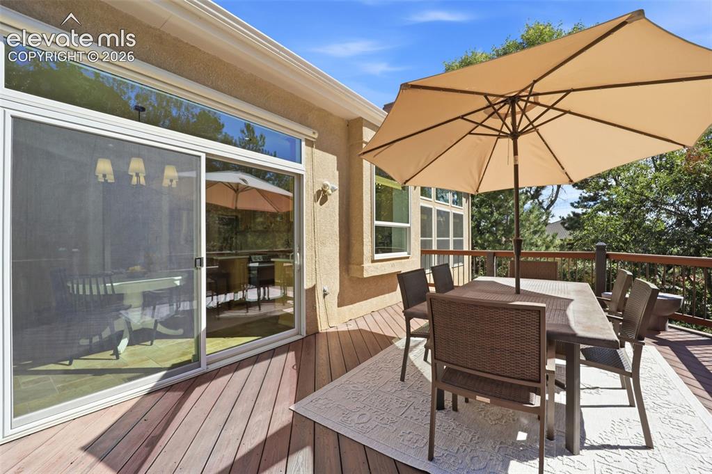 Image 36 of 50: Expansive outdoor trex deck overlooking a mature and treed backyard