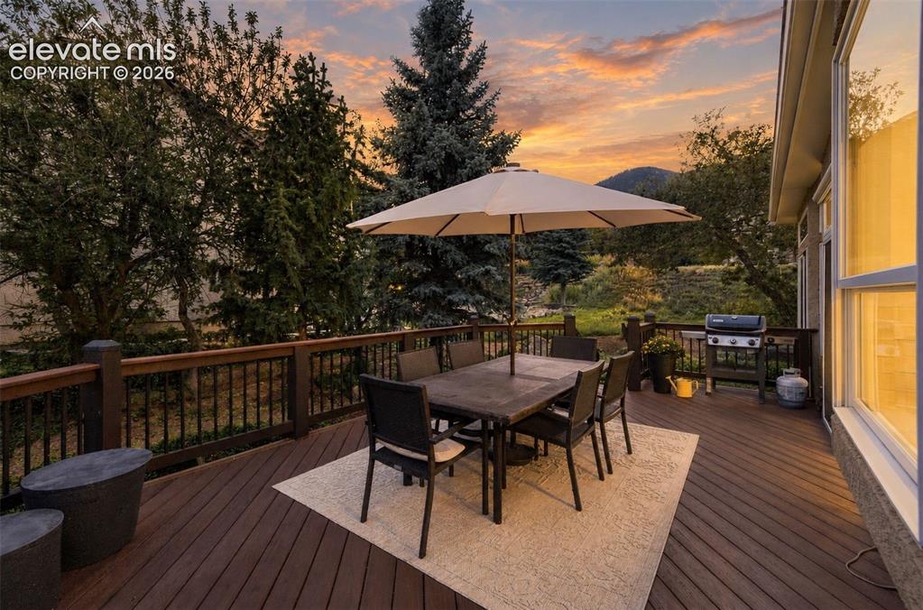 Image 37 of 50: Expansive outdoor deck with composite decking and dark wood railings