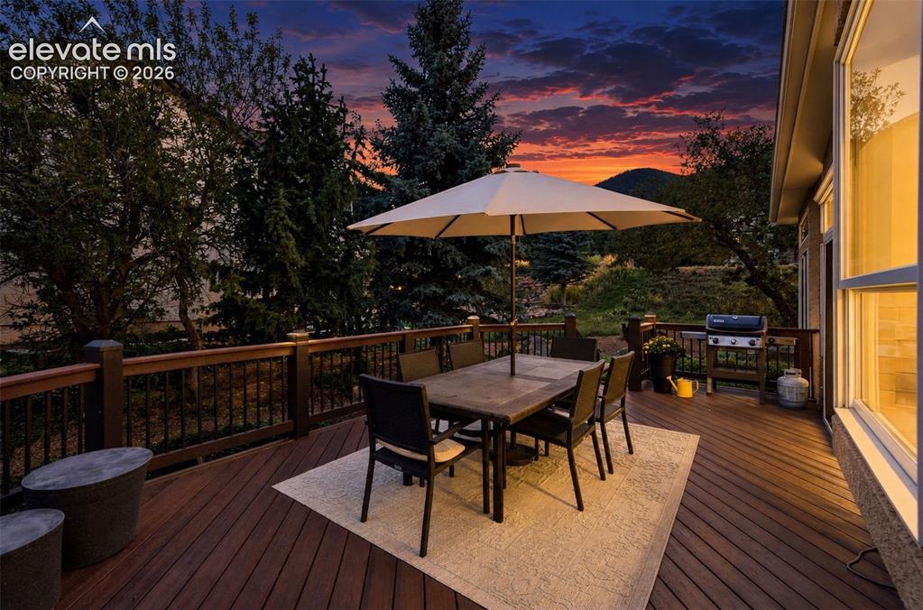 Image 41 of 50: Expansive outdoor deck with composite decking, wood railings, and metal bal