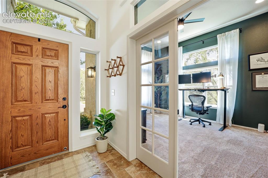 Image 6 of 50: Solid wood entry door with transom window, side-light window, tile flooring