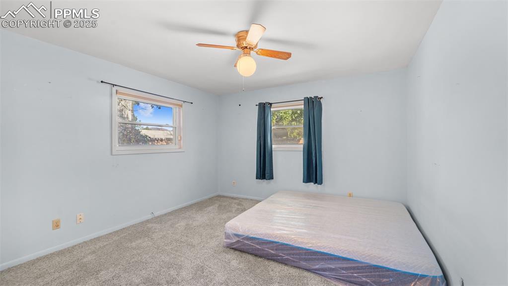 Image 10 of 33: Bedroom featuring carpet flooring and ceiling fan