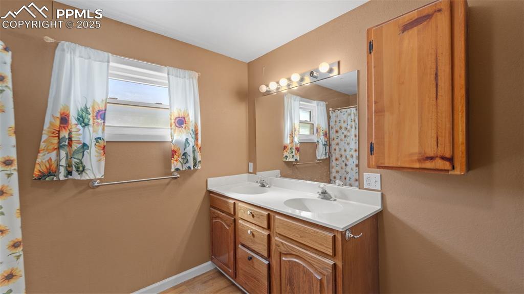 Image 13 of 33: Full bath featuring double vanity and a shower with shower curtain