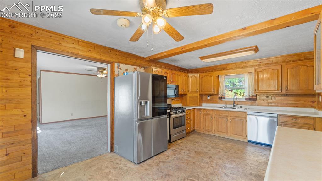 Image 15 of 33: Kitchen featuring appliances with stainless steel finishes, light counterto