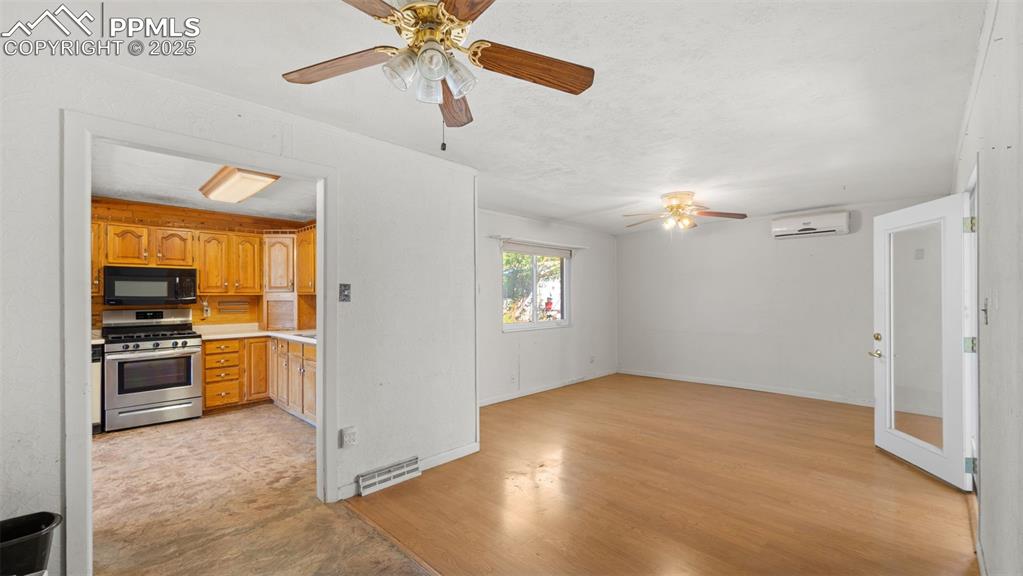 Image 16 of 33: Unfurnished living room featuring light wood-type flooring, ceiling fan, an