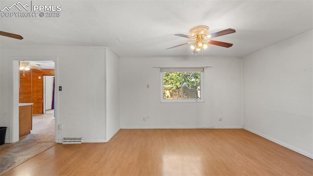Image 17 of 33: Empty room featuring a ceiling fan and light wood-style flooring