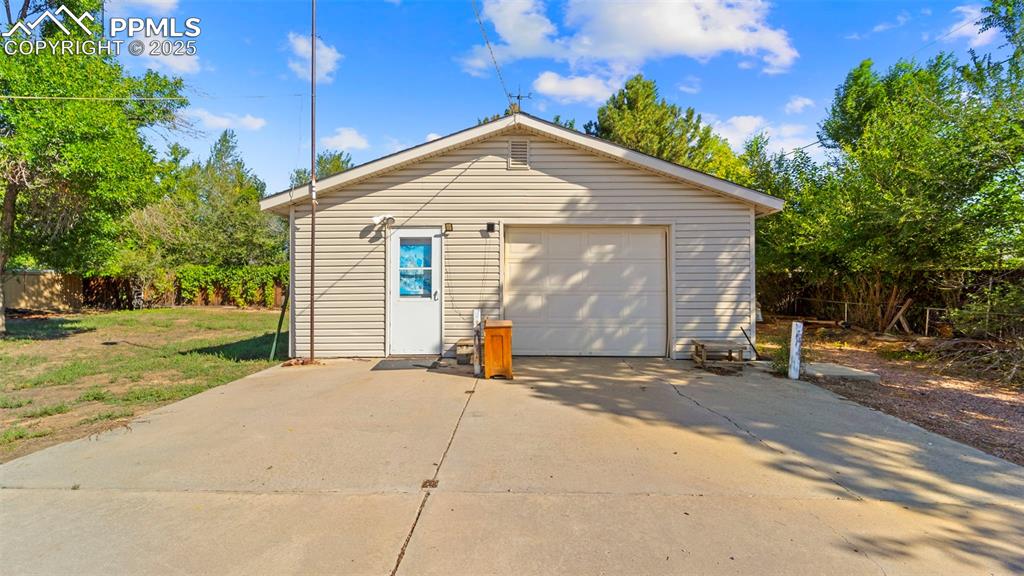 Image 5 of 33: Detached garage featuring driveway