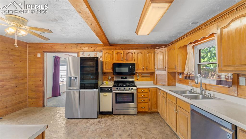 Image 7 of 33: Kitchen with healthy amount of natural light, light countertops, appliances