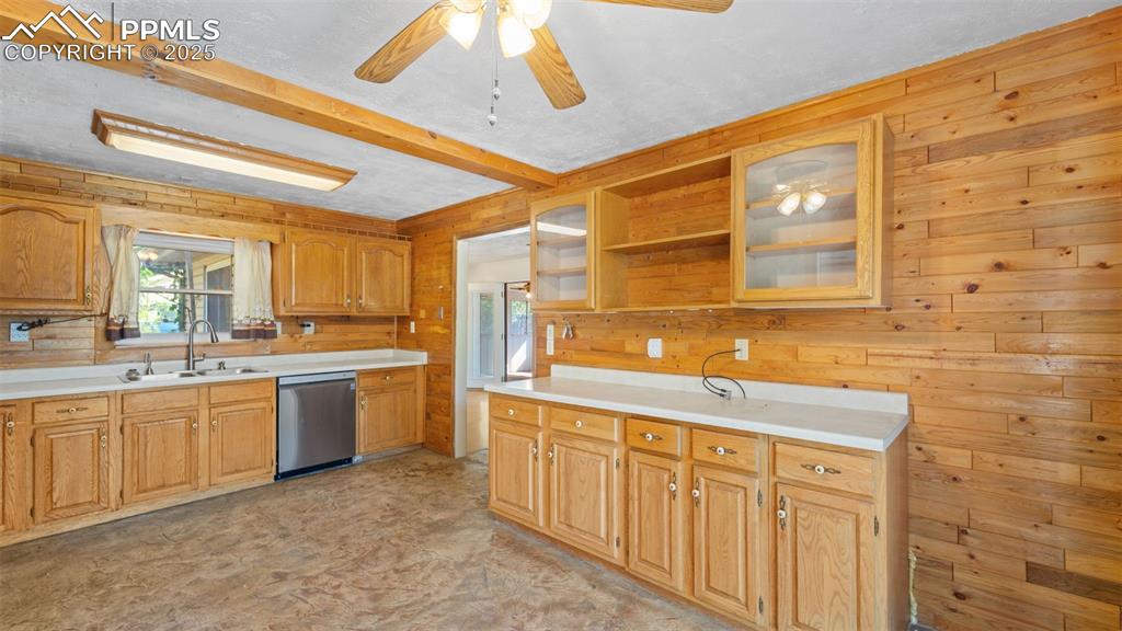 Image 8 of 33: Kitchen featuring wooden walls, plenty of natural light, open shelves, ligh