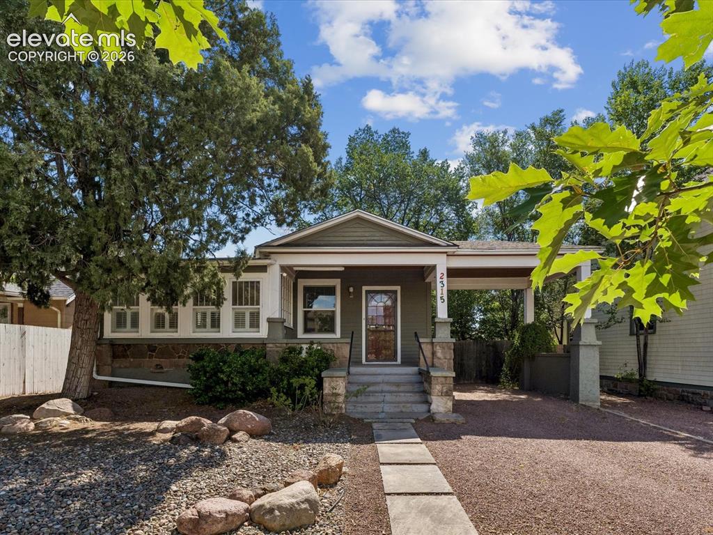 Image 1 of 35: Bungalow-style home featuring a covered front porch with stone accents and