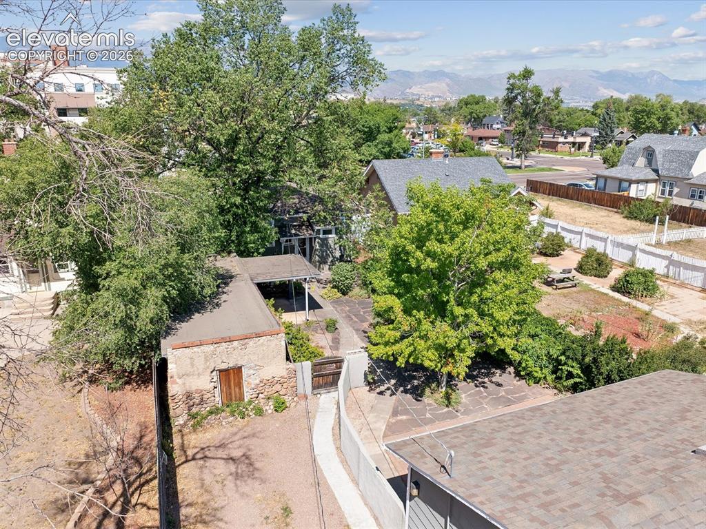 Image 28 of 35: Aerial perspective showcasing a multi-level property with mature trees
