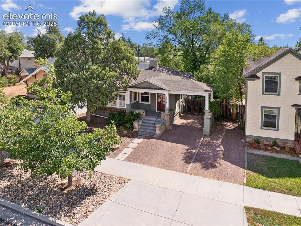 Image 3 of 35: Single-story property featuring a covered entry porch, dark red front door,