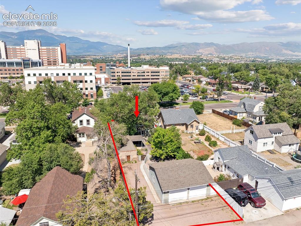Image 32 of 38: Aerial perspective showcasing a property outlined in red, featuring a two-c