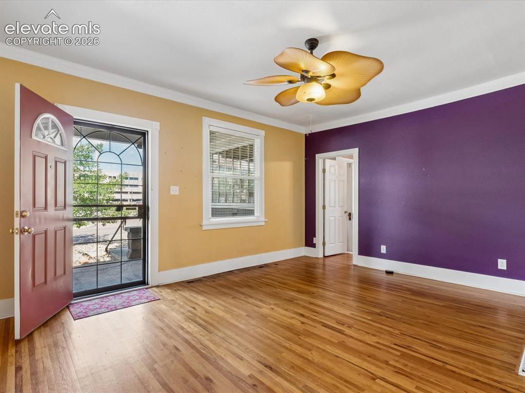 Image 6 of 35: Entry area featuring wood-finish flooring, a decorative ceiling fan, and a