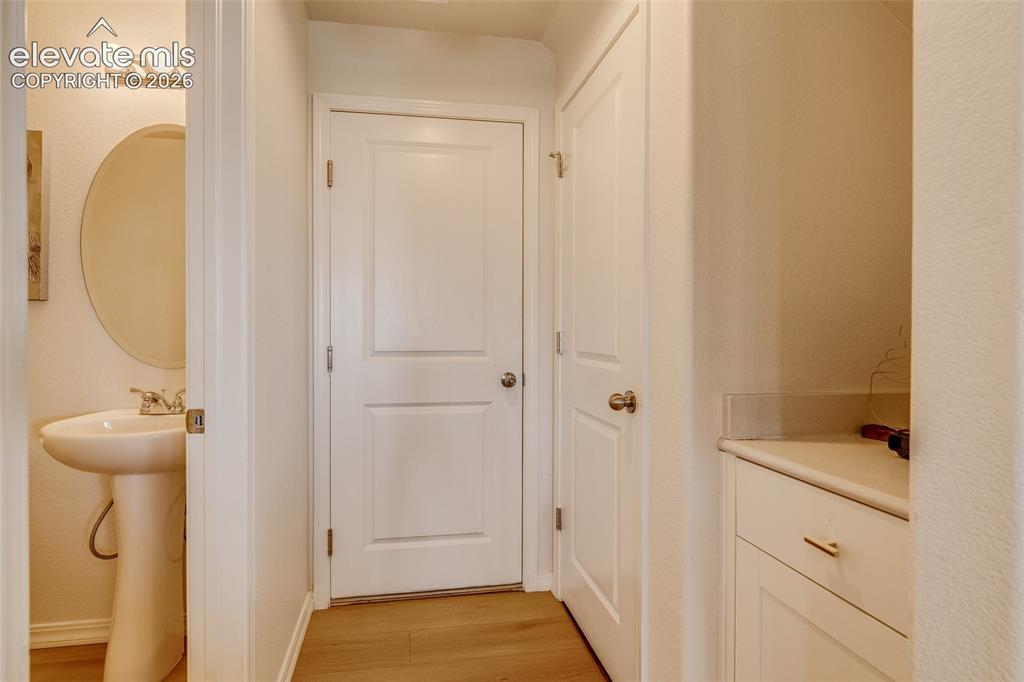 Image 11 of 39: Half bath, garage door and coffee bar area