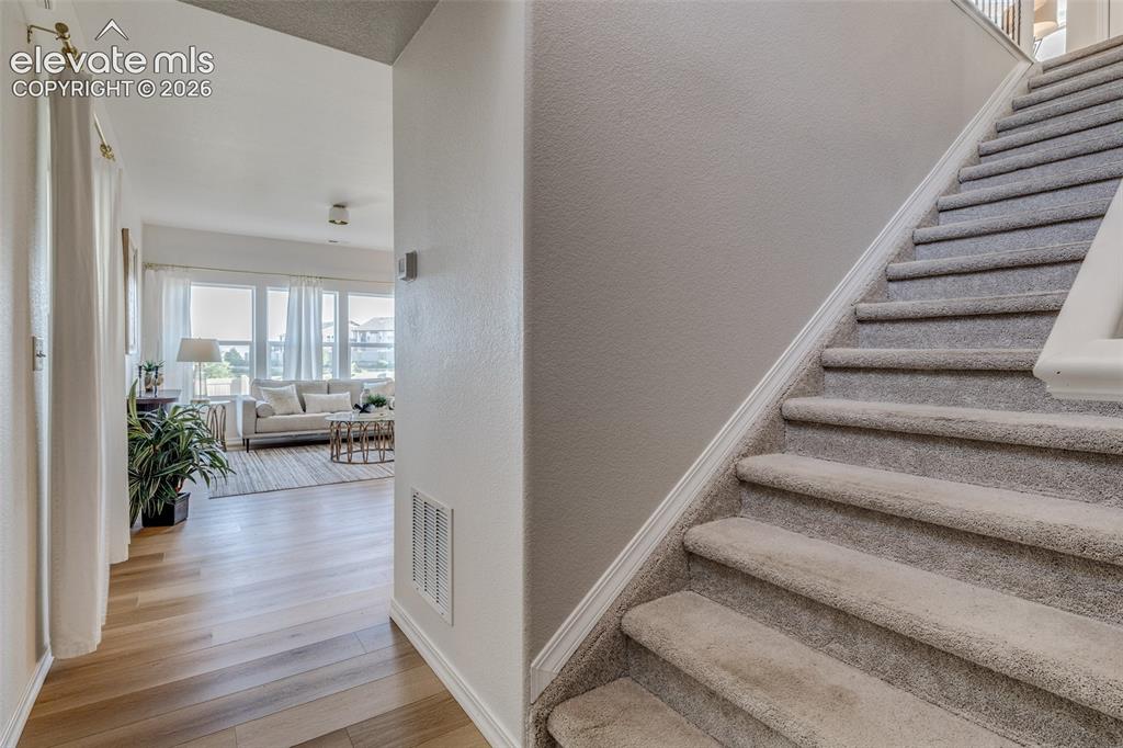 Image 13 of 39: From the front door you can go up the stairs or go down the hallway into th