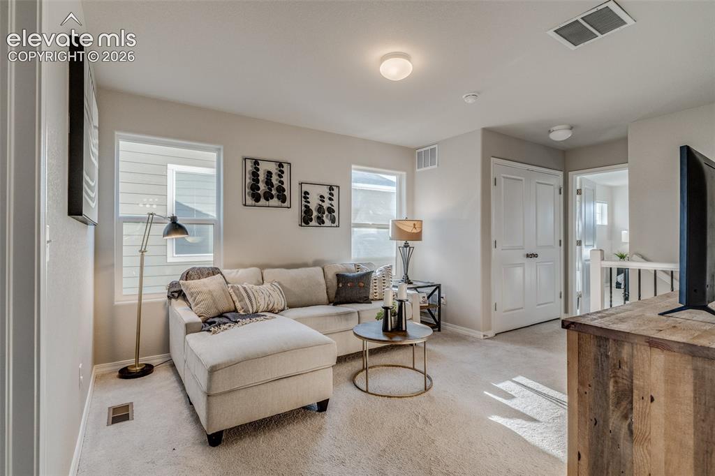 Image 15 of 39: Upstairs in the loft area can be an extra living area, office, craft area a