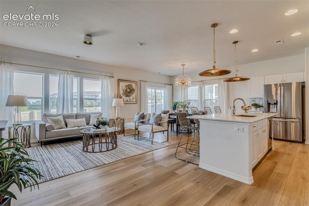 Image 6 of 39: Great room concept with the kitchen and livingroom combined