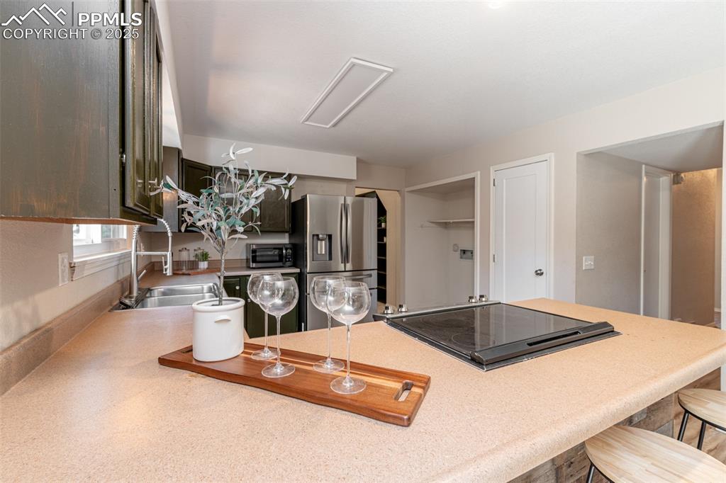 Image 11 of 38: Kitchen with appliances with stainless steel finishes, a kitchen breakfast
