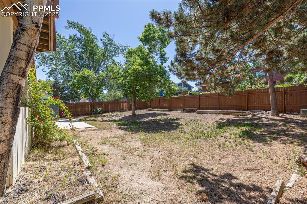 Image 22 of 38: View of fenced backyard