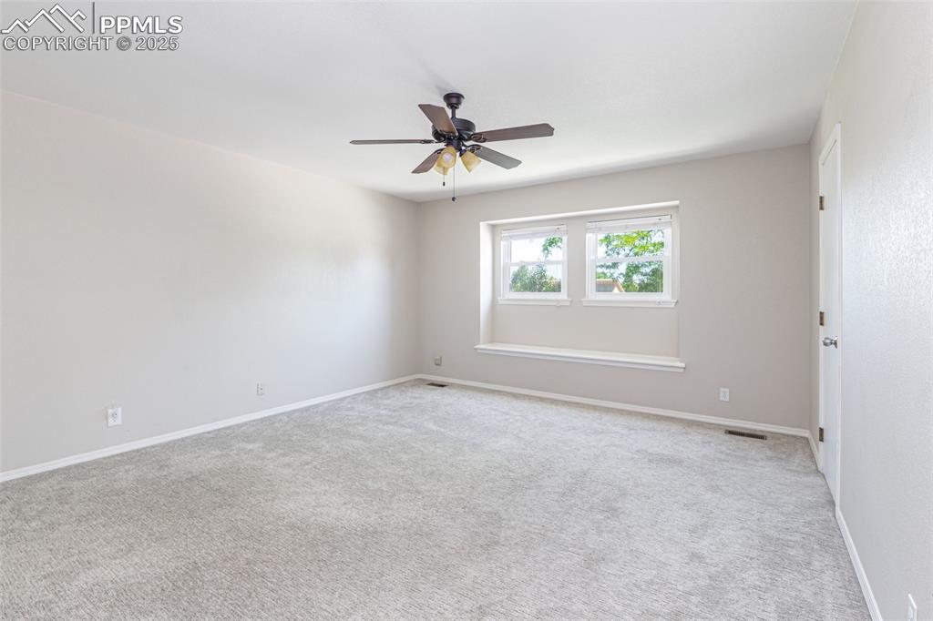 Image 23 of 38: Unfurnished room featuring a ceiling fan and carpet flooring