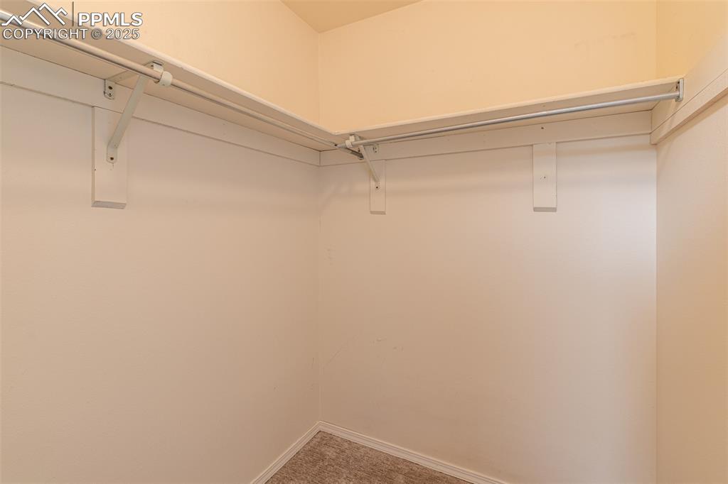 Image 27 of 38: Spacious closet with light carpet