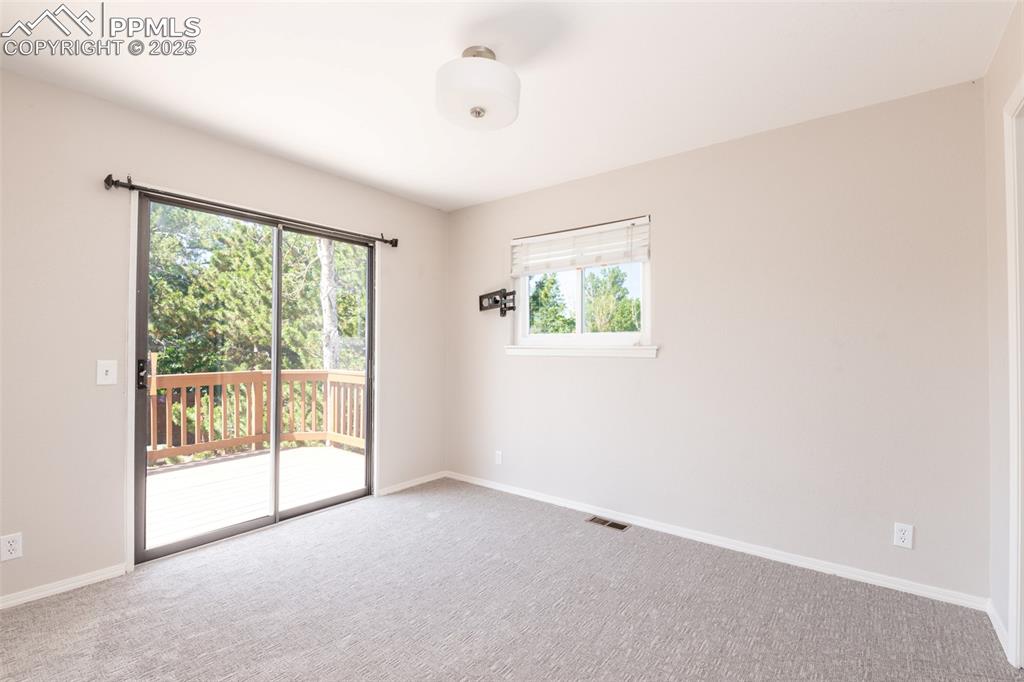 Image 28 of 38: Carpeted empty room with baseboards