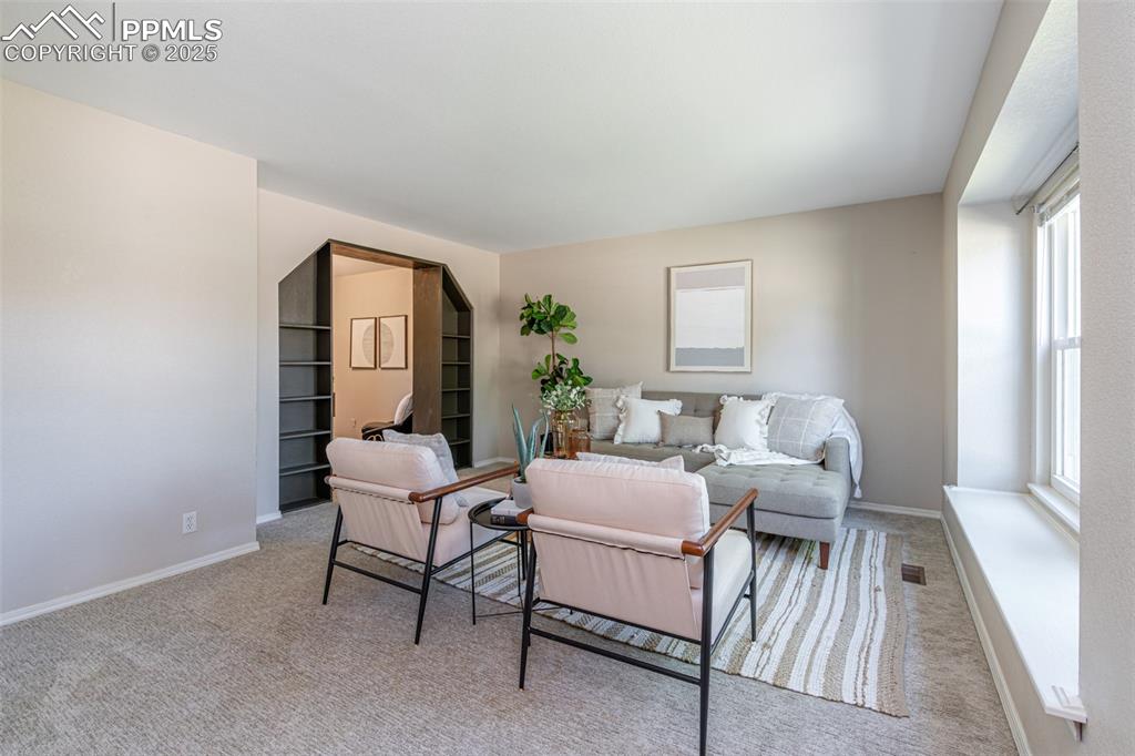 Image 5 of 38: Living room featuring healthy amount of natural light and carpet