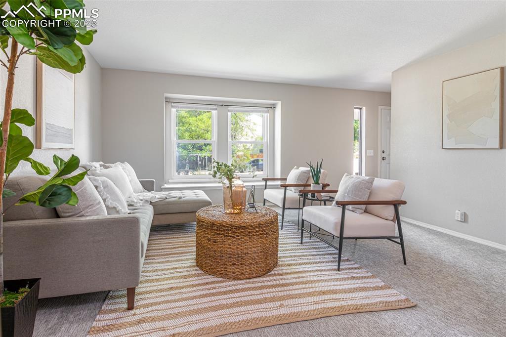 Image 7 of 38: Carpeted living area featuring baseboards