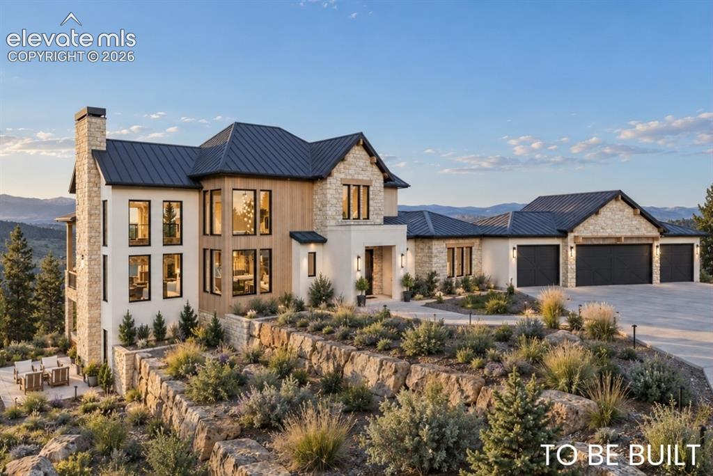 Caption: Hill Country Contemporary  architectural design with multiple gables and a dark metal roof