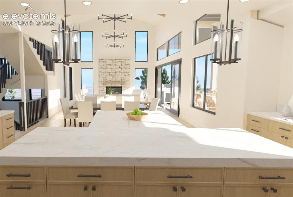 Image 10 of 32: Expansive kitchen island with a light-toned countertop, light wood-finish c