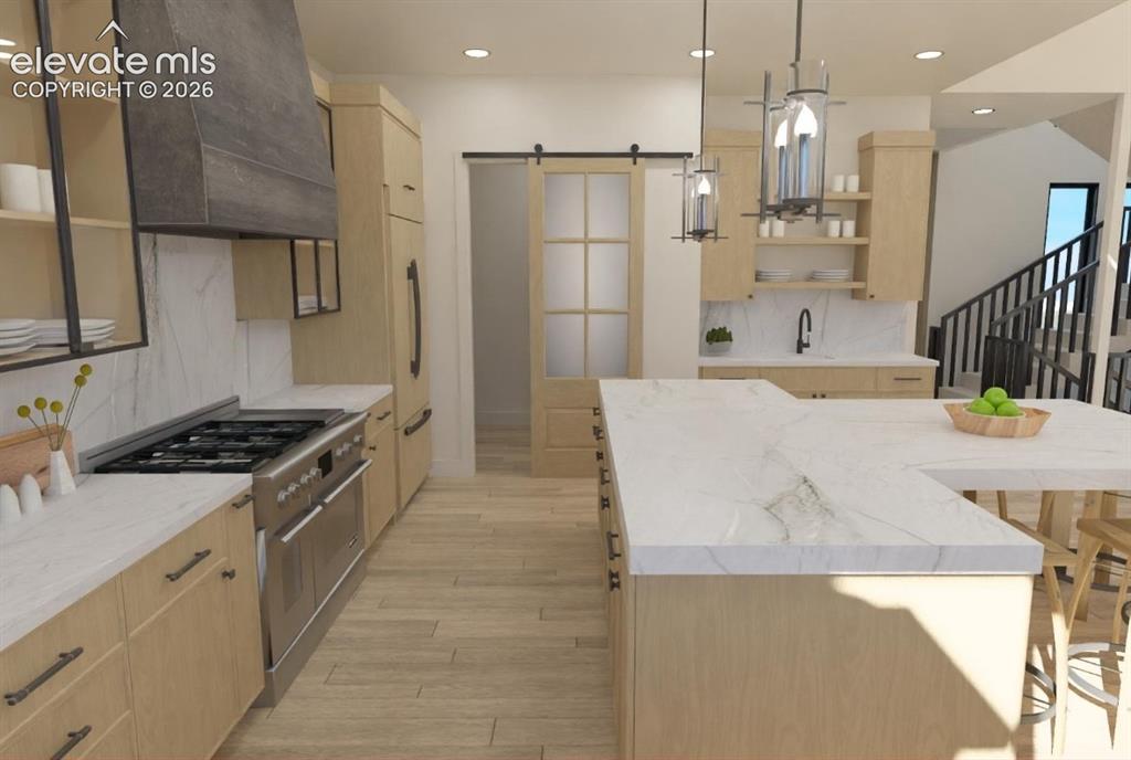 Image 11 of 32: Kitchen featuring light wood-finish cabinetry, stainless steel appliances, 