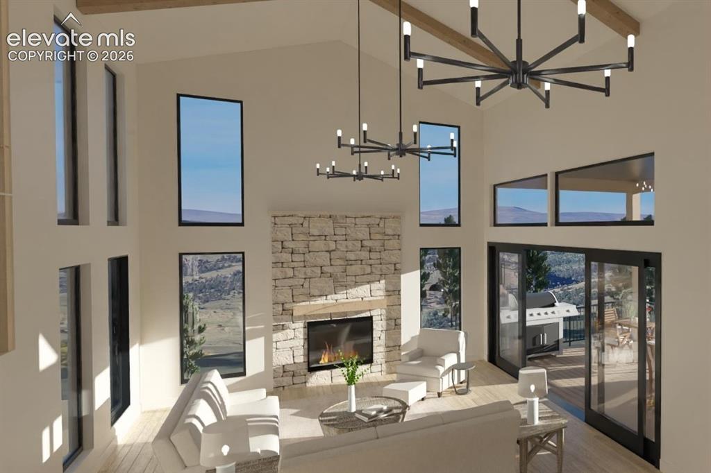 Image 13 of 32: Vaulted ceiling with exposed wood beams, stone-clad fireplace with wood man